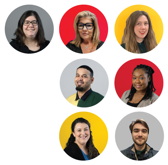 team members standing in front of a wall and smiling